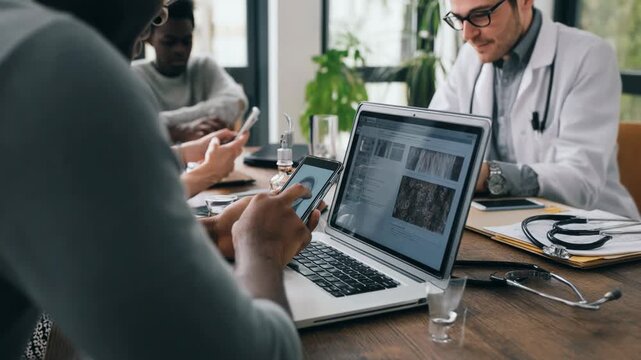 Diverse medical team collaborates on patient care using technology and data analysis