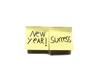 New Year and success message on sticky notes isolated on white background