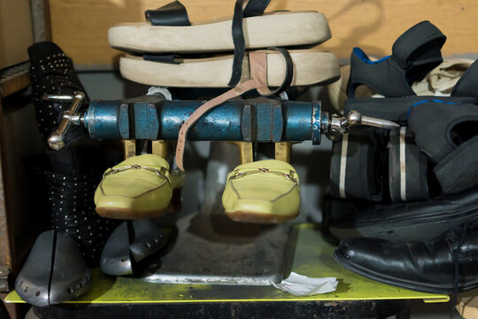 Senior Latino upholsterer meticulously repairs a backpack in his workshop