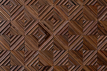 Naklejka premium Intricate wooden wall paneling featuring a geometric chevron like pattern