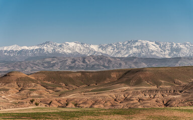 View of Agafay Desert with High Atlas Mountains in Morocco