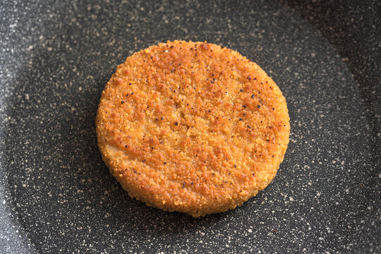 Top view macro photography of fishburger in the nonstick pan