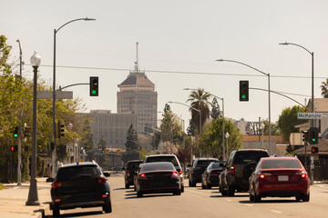Afternoon traffic passes on a city street in downtown Fresno, California, USA.
