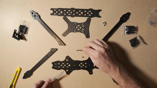 FPV drone quadcopter frame assembly at home. Modern weapon crafted by an enthusiast volunteer in Ukraine.