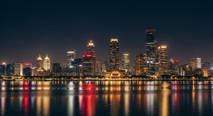 Fototapeta premium City skyline at night with reflections on water