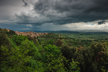 Fototapeta premium The historic town of Montalcino perched on a hill, famous for its Brunello wine. Classic Italian architecture surrounded by vineyards and the golden light of the Mediterranean.