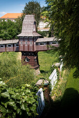 Traditional wooden windmill with ornate balcony in garden