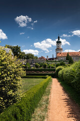 Formal baroque garden with hedges and castle tower