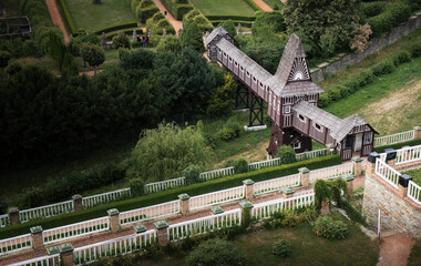 Historic wooden windmill in formal terraced gardens aerial view