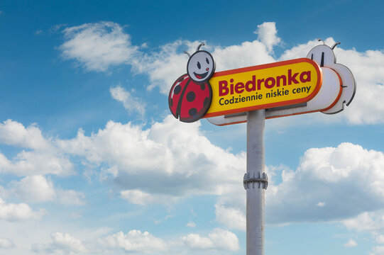Elblag, Poland 15.03.2026 Biedronka supermarket sign on pole against blue sky with clouds in Poland