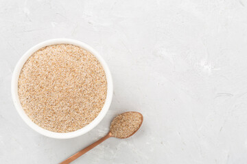 Psyllium husk powder with fresh leaves on concrete background, top view © Liami