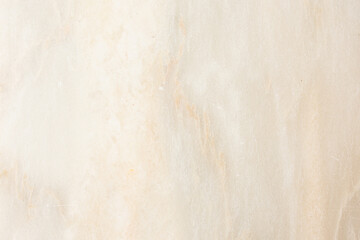 Fototapeta premium A high-resolution background of polished beige marble featuring natural orange and white veining for interior design and architectural visualization. Stock photo