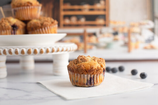 Freshly Baked Blueberry Muffins on a White Countertop in a Bakery