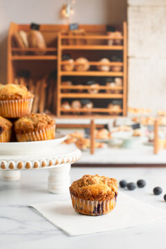 Freshly Baked Blueberry Muffins on a White Countertop in a Bakery