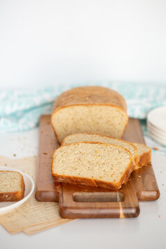 Sliced Pain de Mie on Cutting Board on a White Background