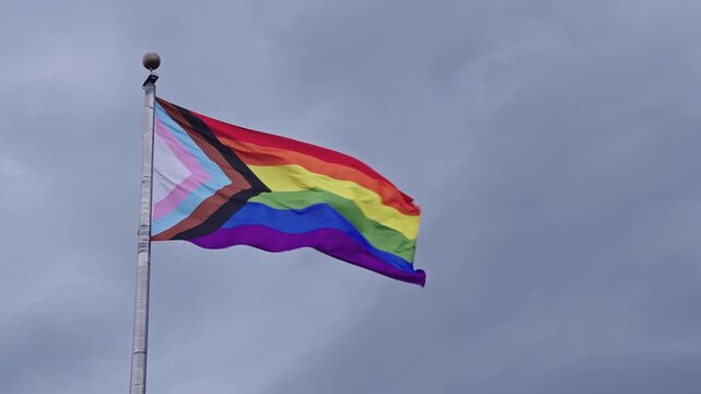 LGBT community. Tolerance and equality. World gay pride. Rainbow gay flag. Pride month. LGBTQ rainbow flag. LGBT rainbow flag waving against sky. Symbol of pride and LGBTQ. Colorful pride flag