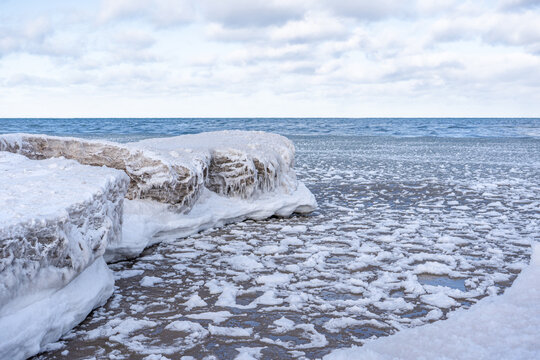 cy Winter Coastline with Floating Ice and Snow-Covered Shore
