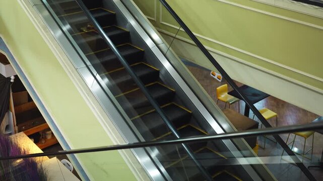 Moving up the escalator with glass sides