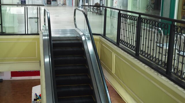 Moving up the escalator with glass sides