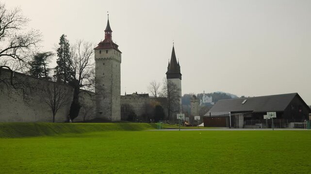 Panning shot along the historic Musegg Wall featuring the well-preserved medieval watchtowers and fortifications of the old town
