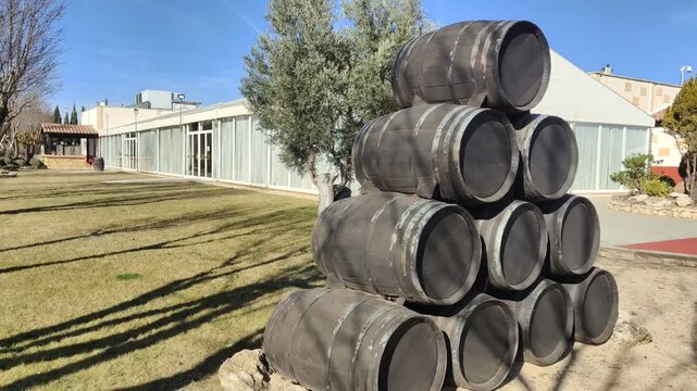 Pyramid of old wooden wine barrels decorating a winery garden
