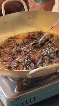 Closeup of Woman Frying Tarantula Spiders for Cooking in South East Asia