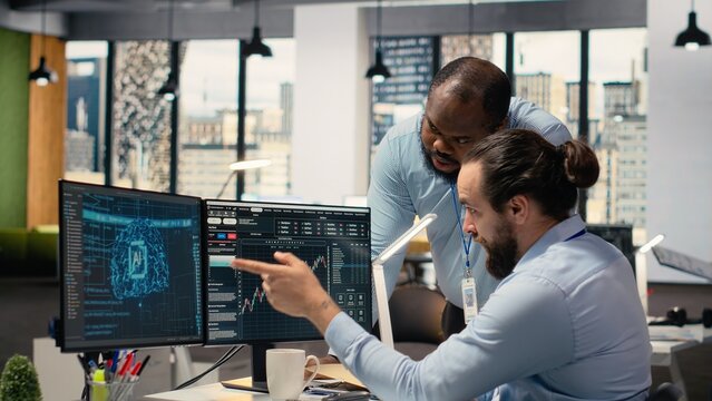 Prop firm manager and employee looking over paperwork, using deep learning to assess stock market volatility. Brokerage company team leader and worker using AI to generate investment reports