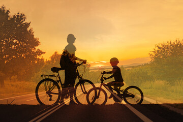 Fototapeta premium Parent and child with bicycles at sunset, family bonding and outdoor lifestyle concept 