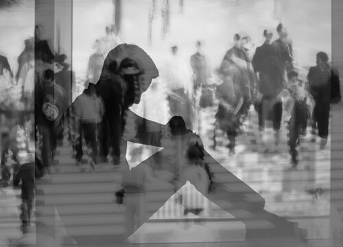 Depressed person sitting alone in crowd, loneliness and mental health concept
