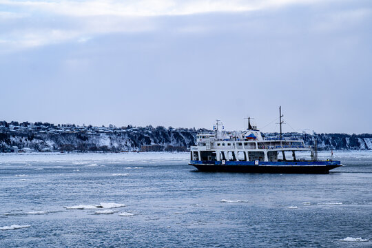 View of a ferry crossing the St. Lawrence River between Quebec City and Levis. Quebec City, Canada - December 21, 2025.
