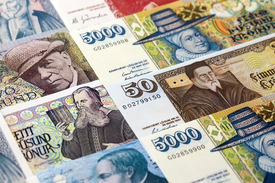 Icelandic krona money bills pile on table. Iceland banknotes of ISK currency close up. Concept of business, economy and banking in Iceland
