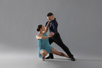 Obraz premium Couple of professional dancers on grey background