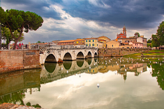 Famous Roman Bridge of Tiberius or Ponte di Tiberio in historic center of Rimini, Italy ,Emilia Romagna at sunset