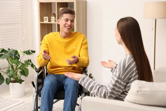Man in wheelchair with woman at home