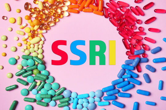 SSRI surrounded by different pills on pink background, top view. Selective serotonin reuptake inhibitor, antidepressants