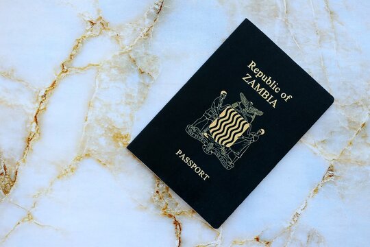Zambian passport on table close up. Official identification document book for citizens of Zambia. Concept of travel and tourism in Zambia