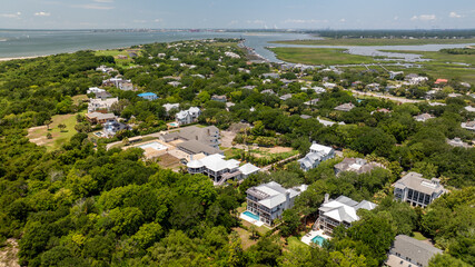 Fototapeta premium Aerial view shows landscapes of Sullivan's Island near Charleston, South Carolina featuring homes and greenery in the lowcountry area