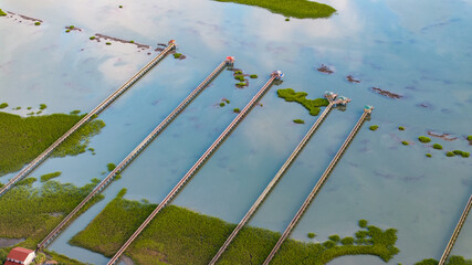 Fototapeta premium Aerial view of marshes and pier boat docks in Folly Beach town near Charleston, South Carolina landscape