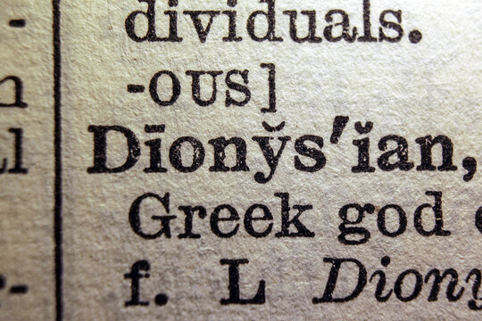Word dyonisiac printed on dictionary page, macro close up