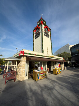 LOS ANGELES, CA, DEC 18, 2025: looking up at The Original Farmers Market clock tower decorated with Christmas wreaths and garland, Taschen bookstore below