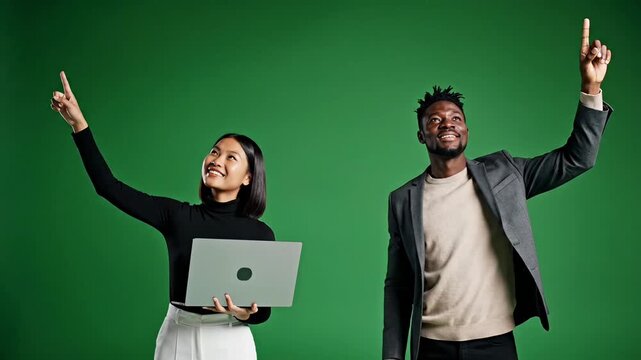 Professional diverse business team pointing up at copy space