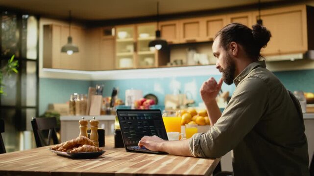Man focused on programming and software development tasks. Laptop screen displays code, scripts and binary data, illustrating system maintenance and remote work in a high-tech occupation.