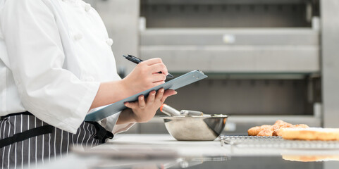 Female staff in the kitchen who check, research, develop products, manage hygiene and quality control for bread.