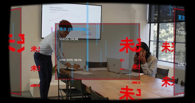 Seated woman holding phone while man moving around table starting AR panels syncing business charts
