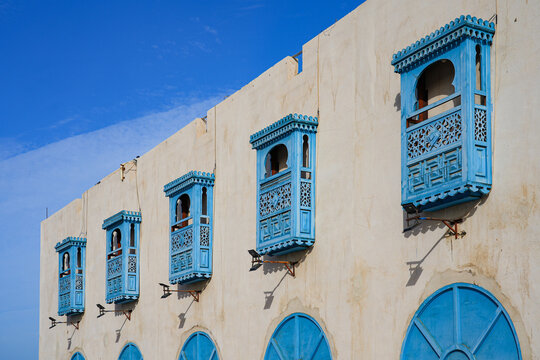 Traditional blue mashrabiya windows at the restored Amerah Souq in Umluj, Saudi Arabia