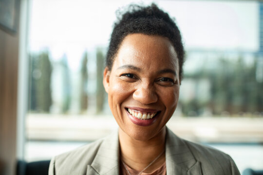 Confident smiling businesswoman portrait in modern office