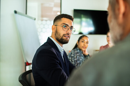Young professionals discussing strategy in office meeting