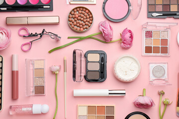 Fototapeta premium Spring composition with different makeup products and flowers on pink background, flat lay