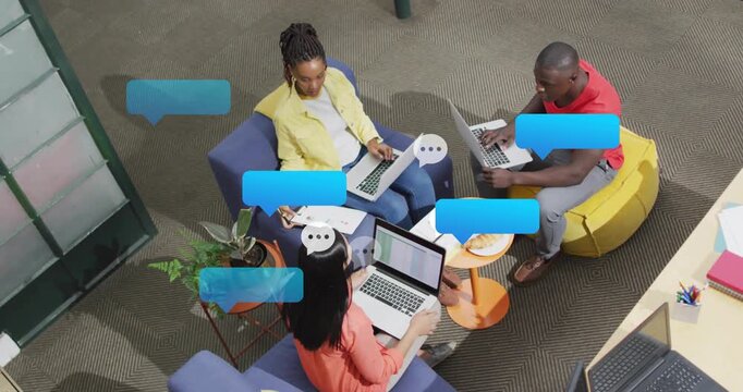 Colleagues typing on laptops, starting chat bubbles building above for business collaboration