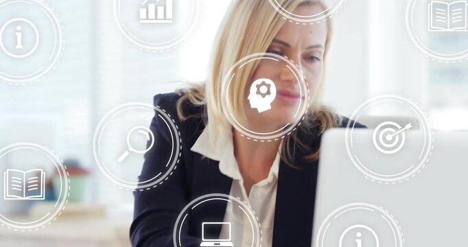 Businesswoman tapping tablet in office, causing HUD data icons and reviewing laptop reports